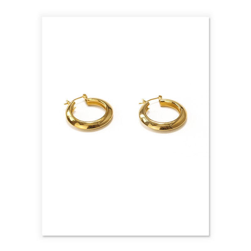 A pair of Circle Earrings by Maramalive™ on a white background.