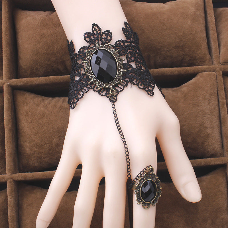 A hand with a Maramalive™ Vintage Gothic Lace Gem Bracelet - Steampunk, Wrist cuff and ring on it.