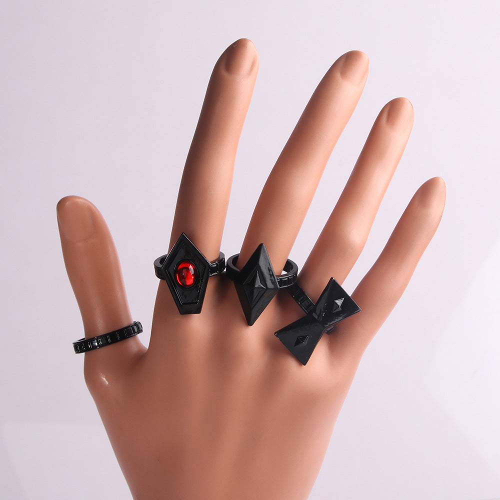 A Mannequin's hand with four Walnut Gothic Ring Sets - Striking Black by Maramalive™.