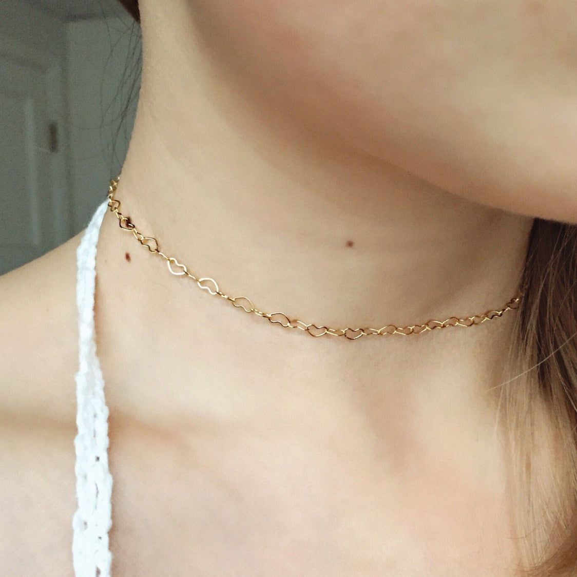 A woman wearing the Maramalive™ Women's Fashionable All-match Copper Heart-shaped Clavicle Necklace.