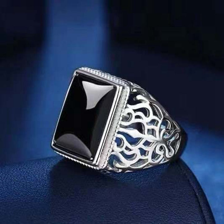 A woman's hand holding a Maramalive™ Silver Plated Black Onyx Men Ring.