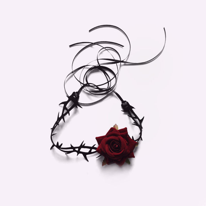 A retro woman wears a Punk Gothic Court Dark Briar Rose choker collar with a flower embellishment from Maramalive™.