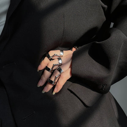A woman wearing a black suit and a Gothic Metal Flex Ring by Maramalive™.