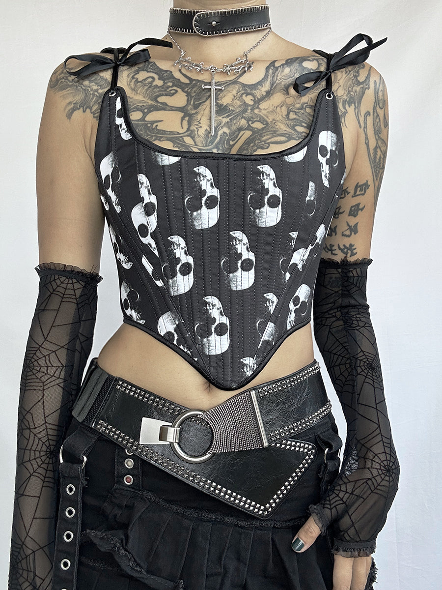 A person wearing the Maramalive™ Exclusive Dark Gothic Punk Corset tie Designs Unveiled with a white skull print, black mesh gloves, a wide belt with metal accents, and a black choker with a cross pendant. Their upper chest and arms have numerous tattoos, exuding an edgy gothic punk vibe.