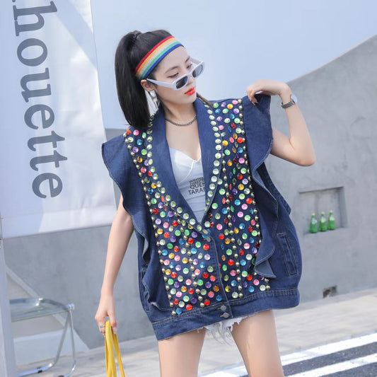 Person wearing a Maramalive™ Heavy Duty Diamond Studded Denim Vest With Wooden Ear Edge, white top, denim shorts, headband, and sunglasses, holding a yellow bag and standing outside near a white structure.
