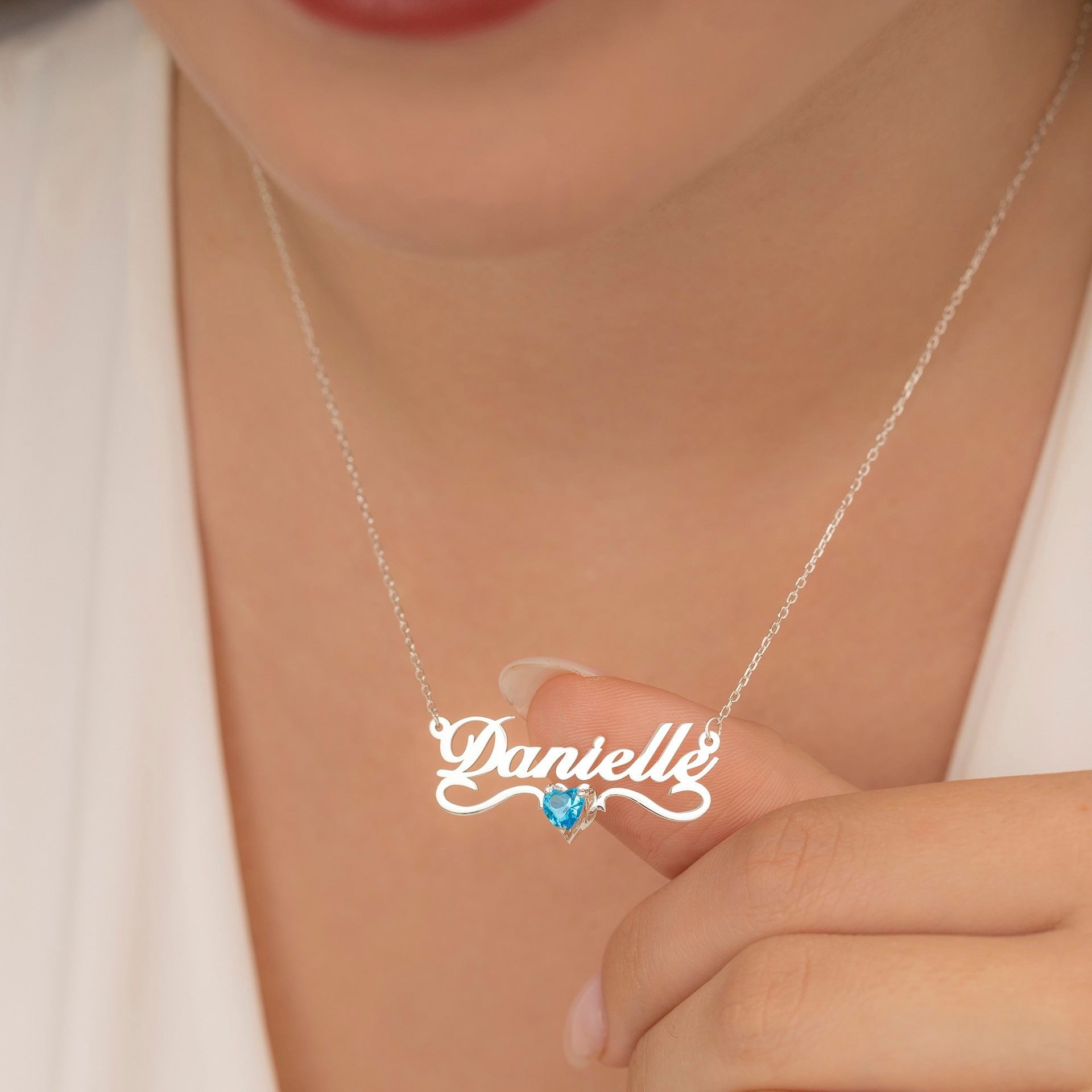 A woman wearing a Maramalive™ Personalized Name Necklace Stainless Steel with an added bonus of a Crystal of your choice with the name Danielle on it.