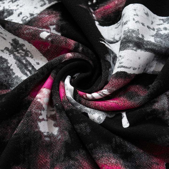 Close-up of a textured fabric on a Maramalive™ Chic Oversized Short Sleeve Tees for Women featuring a swirling pattern with black, white, and pink colors. The loose fit tee appears to be folded or twisted, creating a dynamic visual effect.
