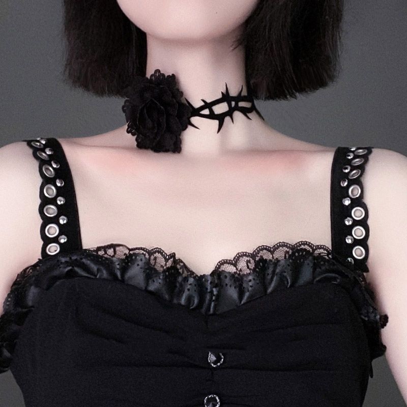 A retro woman wears a Punk Gothic Court Dark Briar Rose choker collar with a flower embellishment from Maramalive™.