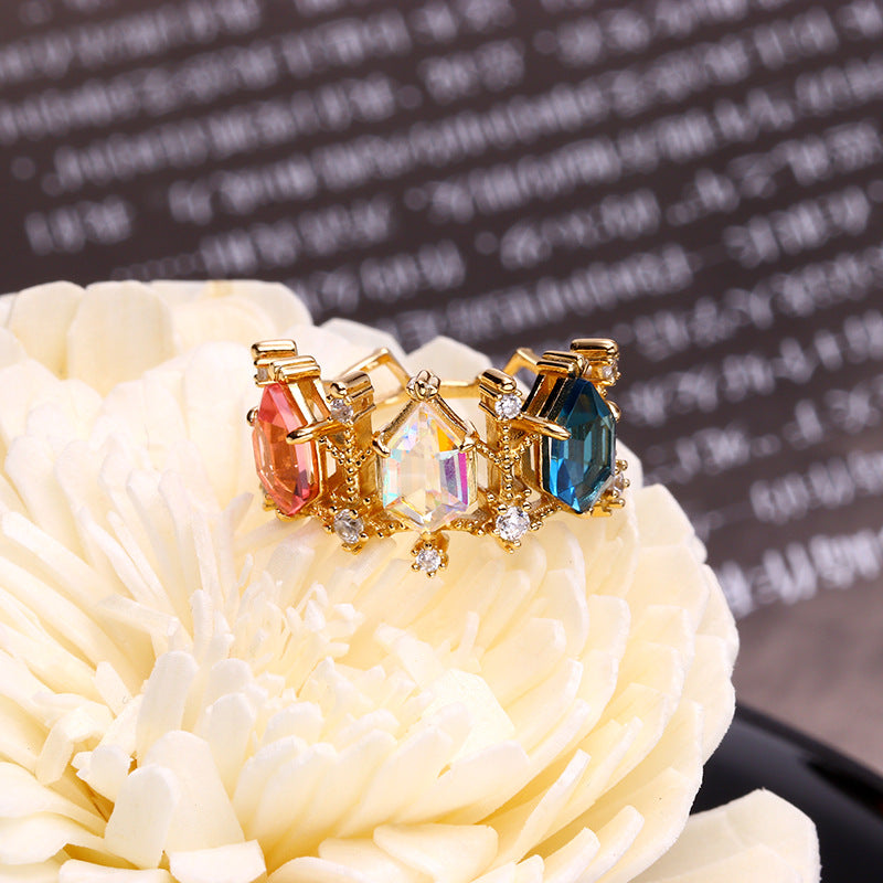 A Maramalive™ Aurora Crystal Lamp Ring with multi colored stones.