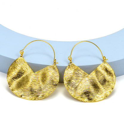 A pair of Maramalive™ Fashion Retro Female Ornament Earrings Alloy Exaggerated on a blue background.