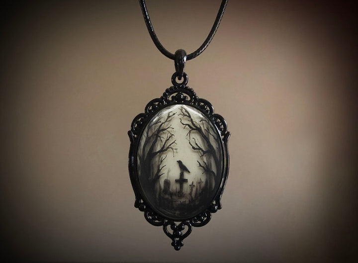 A Gothic Crow Cross Glass Pendant Necklace from Maramalive™ with an image of a crow in the woods.