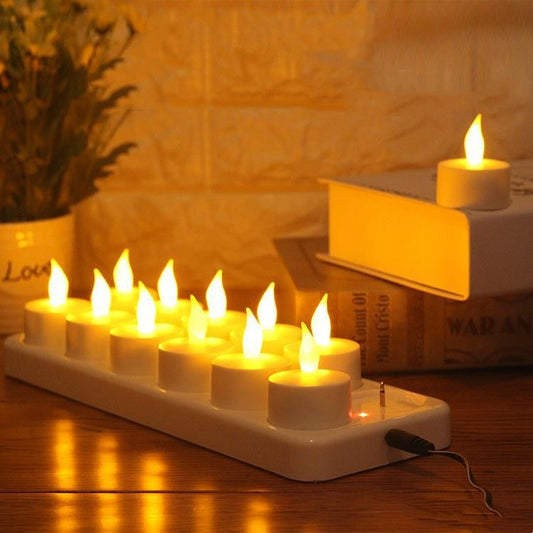 A set of Maramalive™ Rechargeable LED Electronic Candles, 12 Pack on a table next to a book.