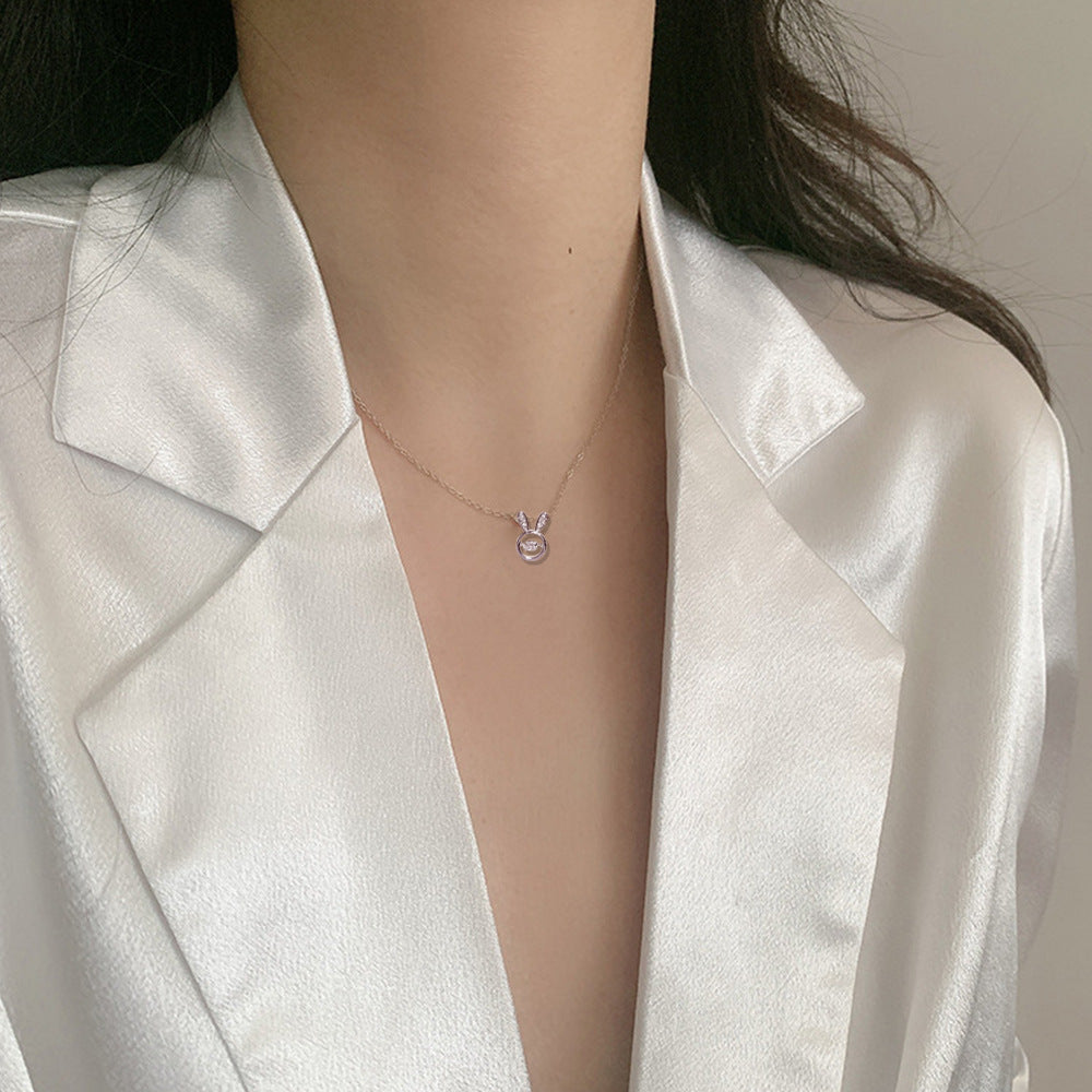 A person holding a card with a Maramalive™ Bunny Necklace Simple All-match Titanium Steel Clavicle Chain on it.