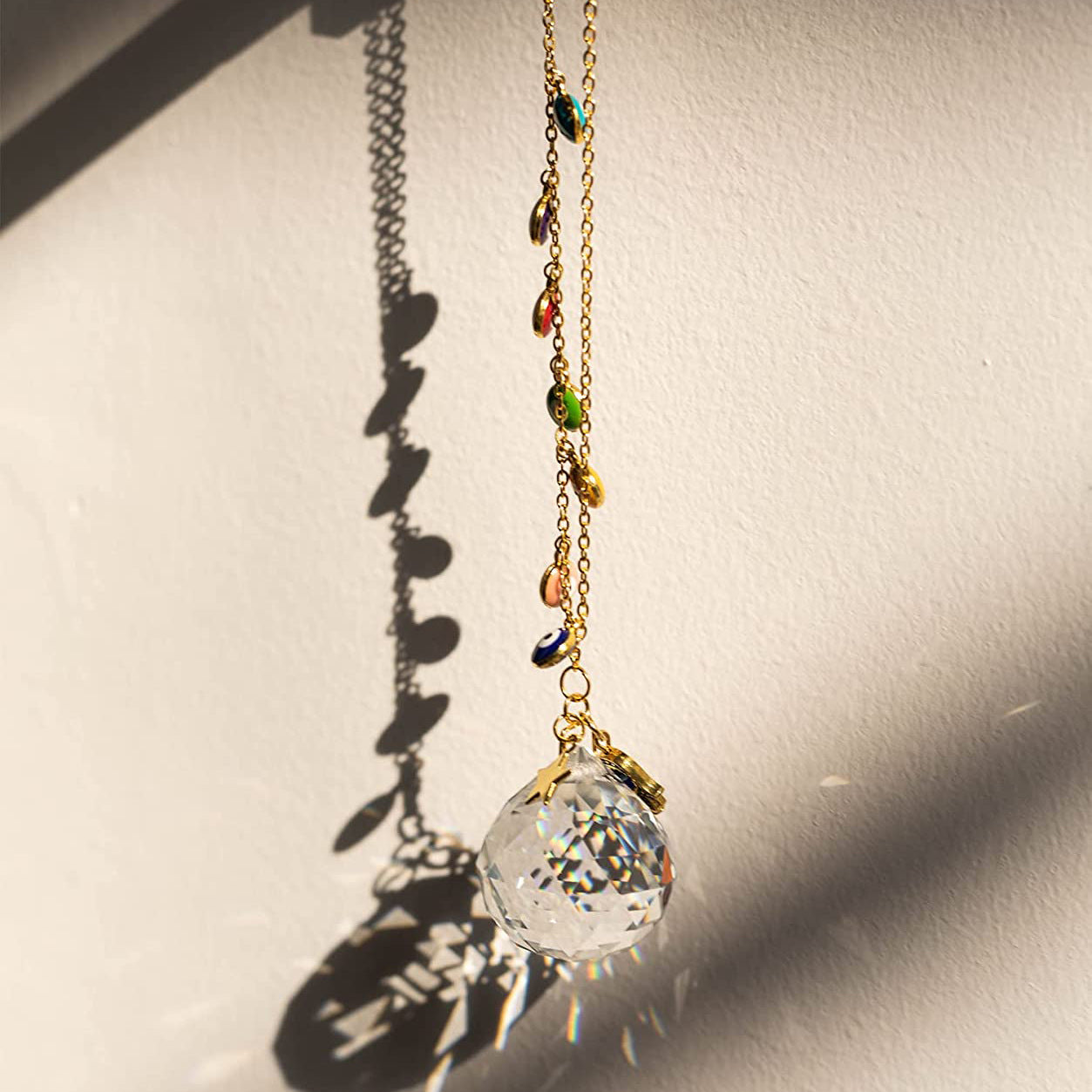 A Maramalive™ Prismatic Crystal Pendant necklace with a multi colored glass ball on it.