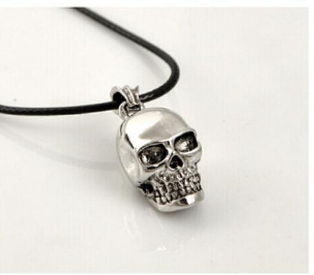 A Titanium Steel Cool Skull Necklace from Maramalive™ on a black background with a chain necklace.