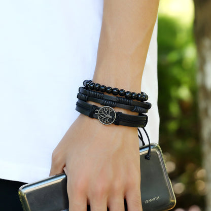 A woman holding a Tree Of Life Men's Leather Woven Bracelet from Maramalive™ and a cell phone.