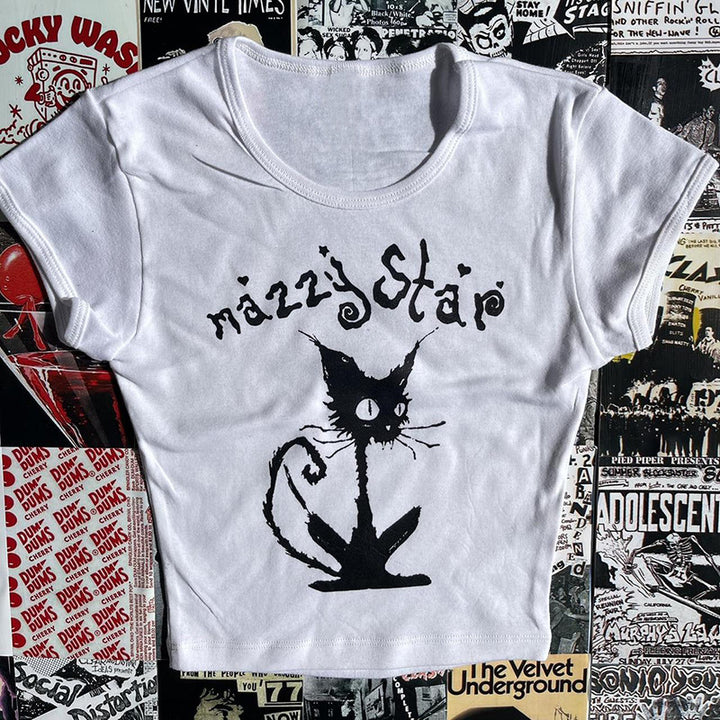 A white, slim-fit Gothic Street T-shirt Women's Printed Black Top with a graphic design of a black cat and the text "mazzy star" on the front, placed against a backdrop of various punk rock posters by Maramalive™.