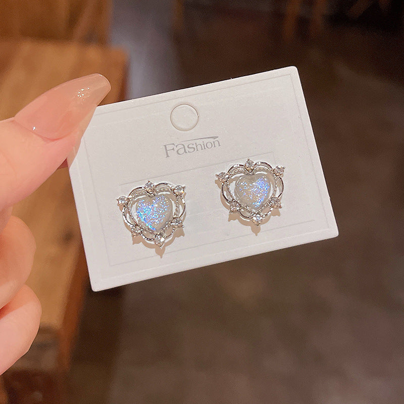 A pair of Sparkling Opal Heart Shape With Diamond Stud Earrings by Maramalive™ on a piece of paper.