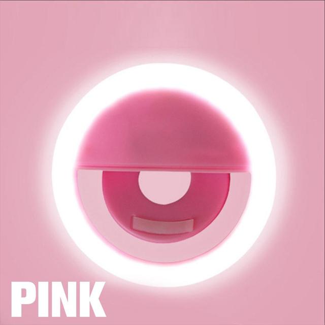 A person holding up a Maramalive™ LED Selfie Ring Light with a pink light on it.