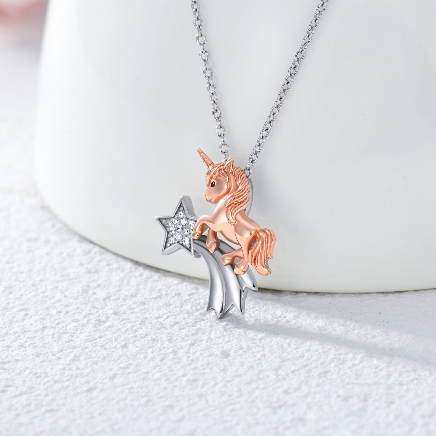 A Maramalive™ CZ Unicorn Horse Necklace in White & Rose Gold Plated Silver with a star on it.