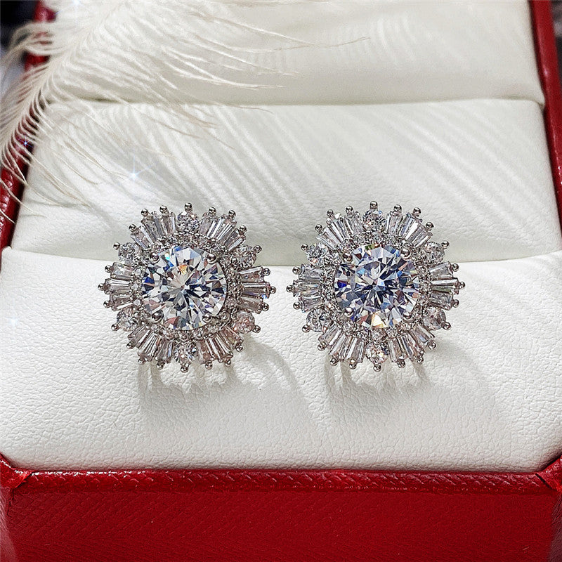 A woman's hand holding a pair of Maramalive™ New High-end Luxury Full Rhinestone Zircon Snowflake Earrings.