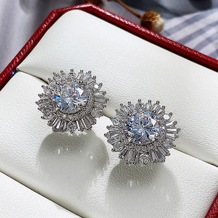 A woman's hand holding a pair of Maramalive™ New High-end Luxury Full Rhinestone Zircon Snowflake Earrings.