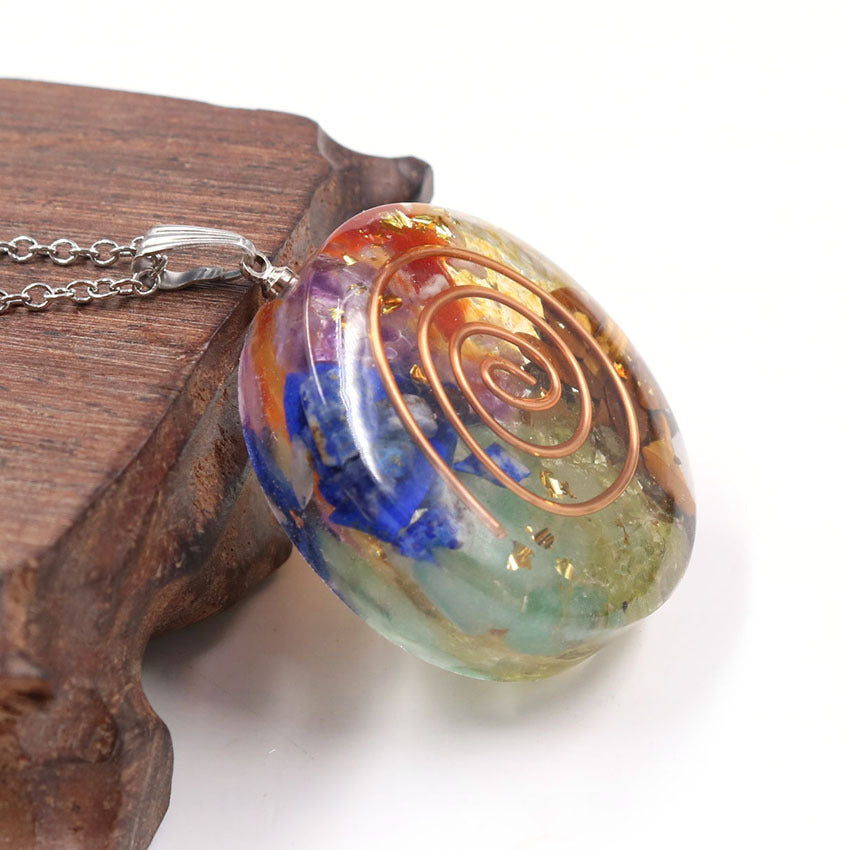 A Maramalive™ Crystal Pendant necklace on a wooden table.