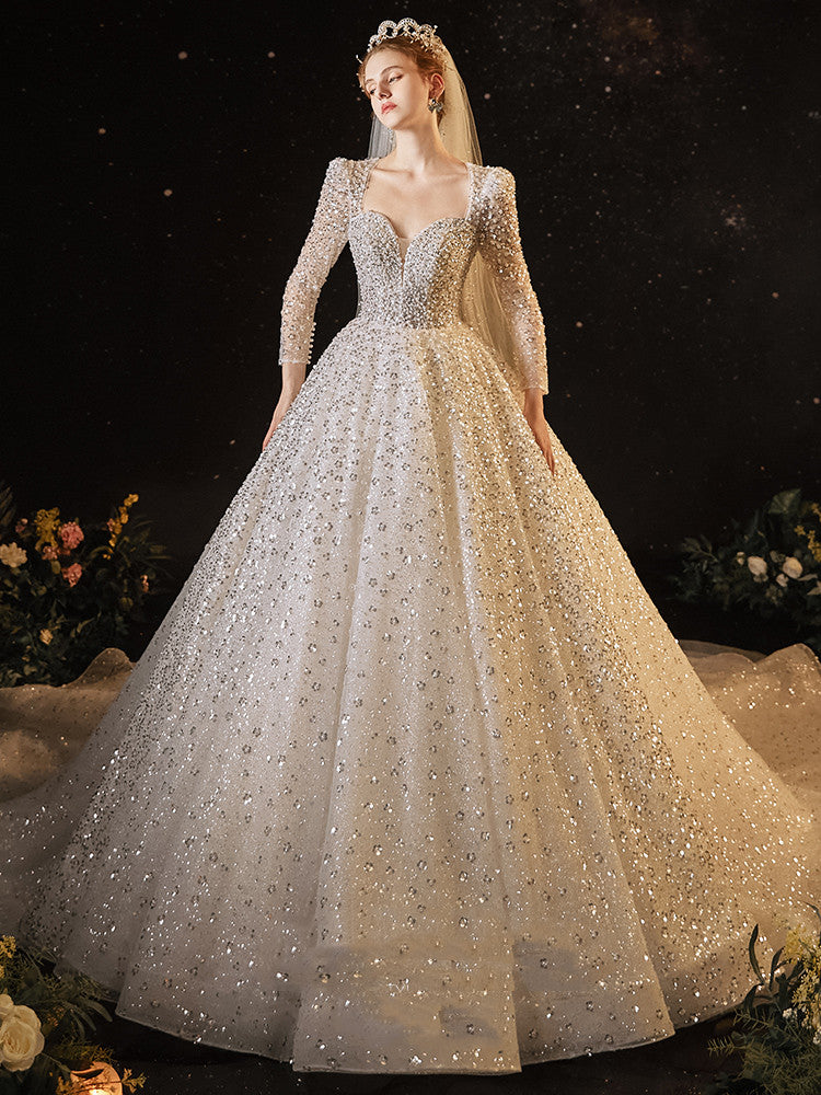 A woman in a Maramalive™ Women's Super Heavy Industrial Wedding Dress with long sleeves and sequins.