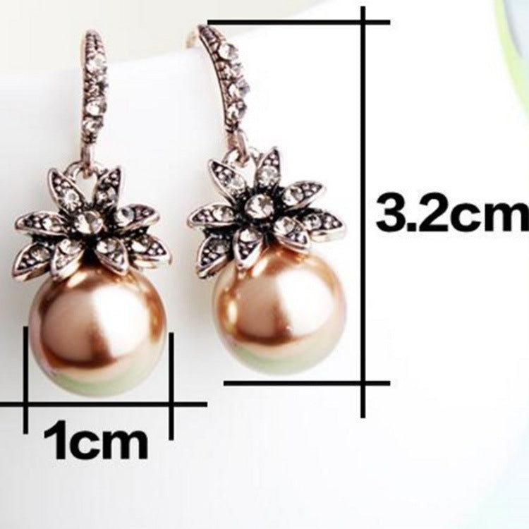 A pair of Maramalive™ gray pearl earrings on a white background.
