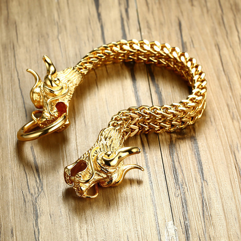 A Maramalive™ Titanium steel men's golden dragon head bracelet with two dragons on it.