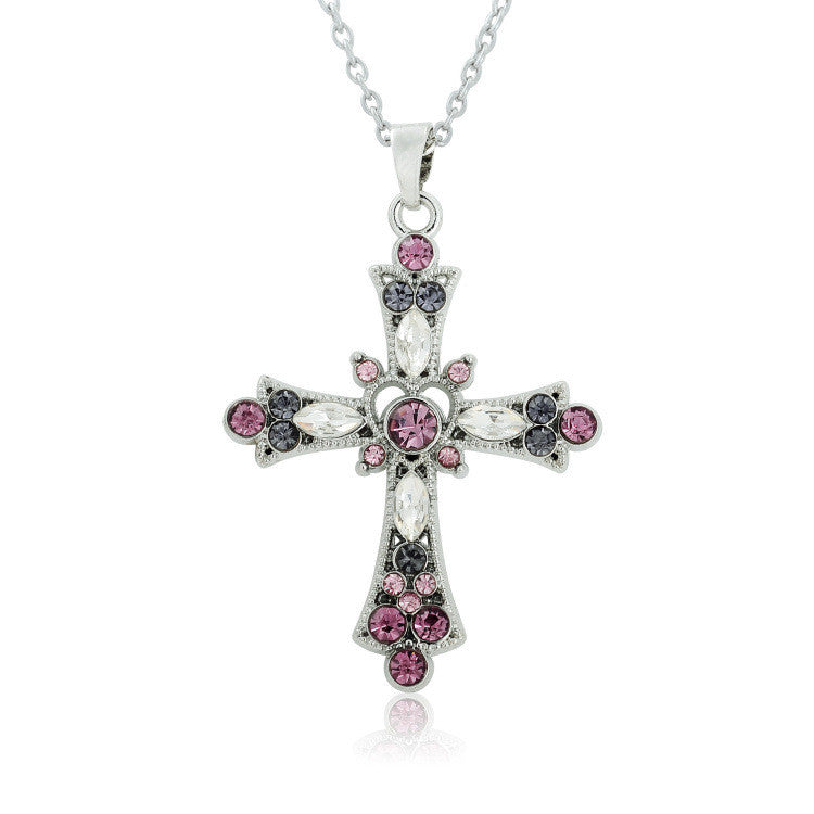 A woman with long blonde hair wearing sunglasses in a car is wearing the Gothic Zircon Cross Necklace from Maramalive™.