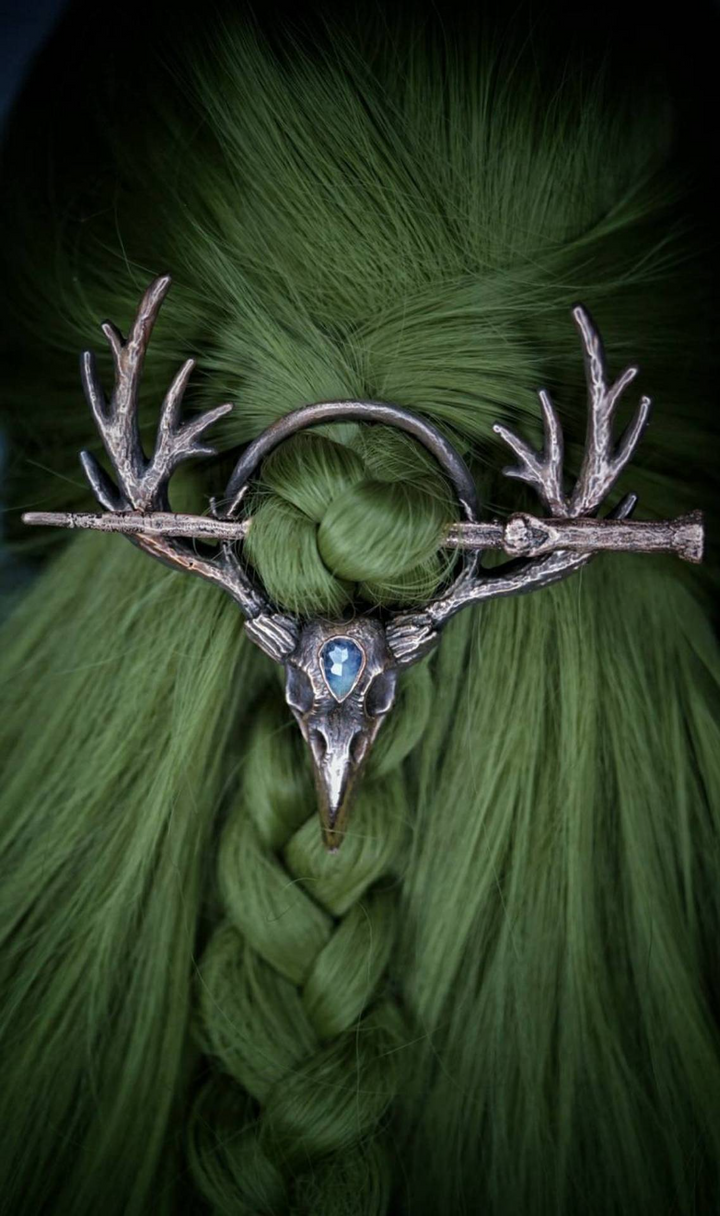 A spooky woman with a Twilight Talon - Gothic Retro Crow Skeleton Moonlight Stone Deer Horn Women's Hairpin by Maramalive™ on her head.