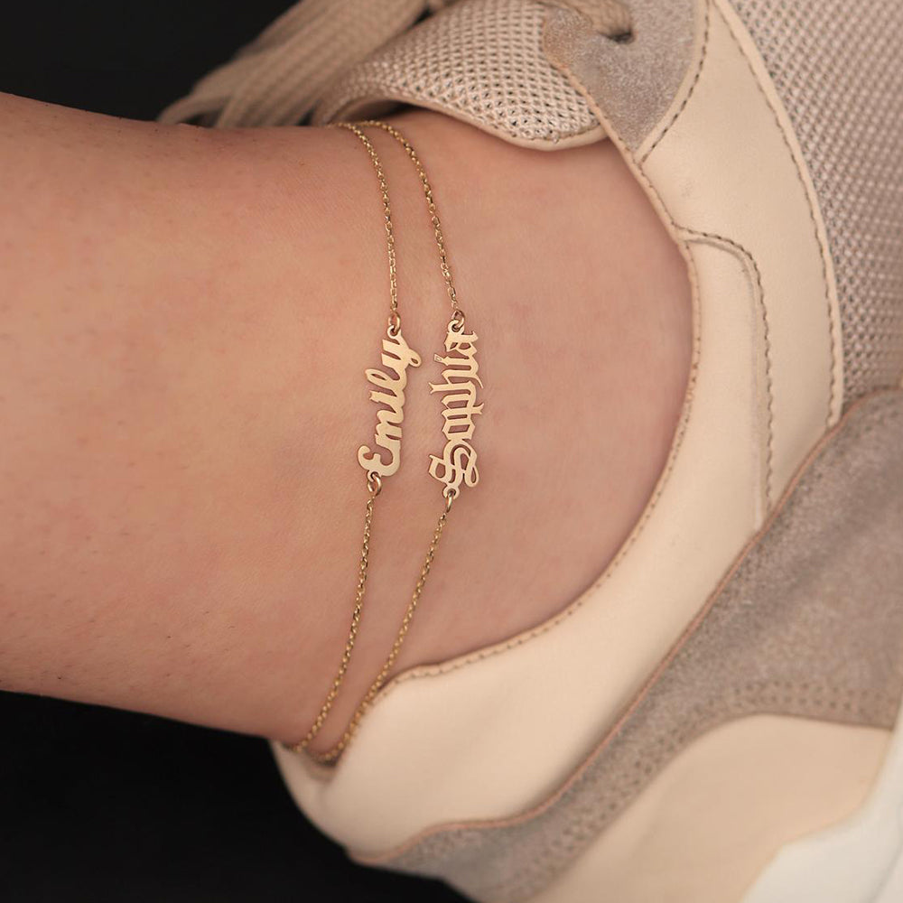 A woman's foot with the MAKE IT YOURS Stainless Steel Jewelry, English Alphabet Name Anklet from Maramalive™ engraved on it.