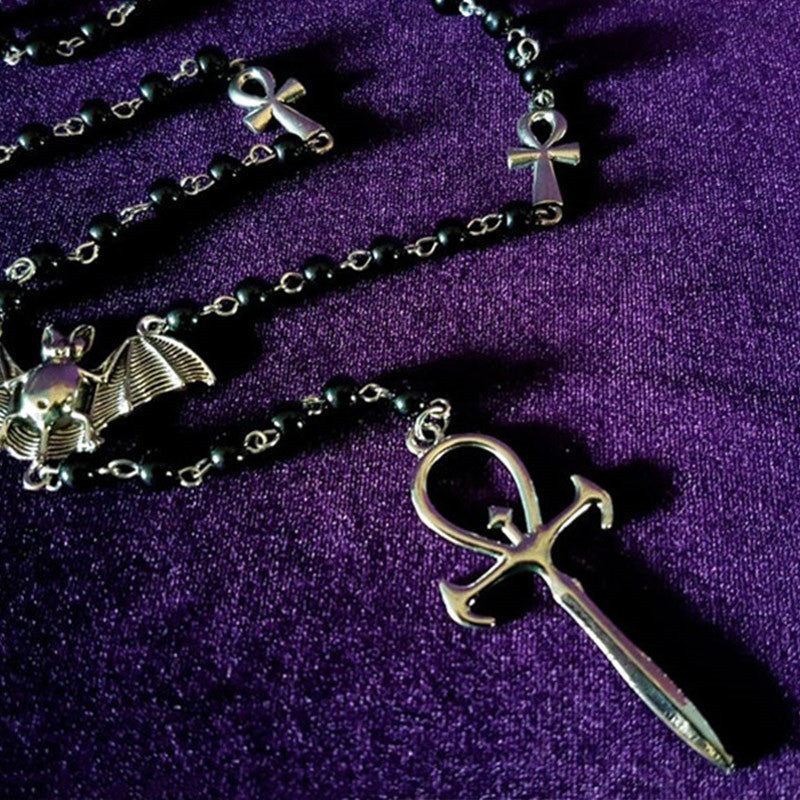 An Maramalive™ Metal Ankh Pendant Necklace Mysterious Gothic with a bat and knife on it, popular in European and American fashion.