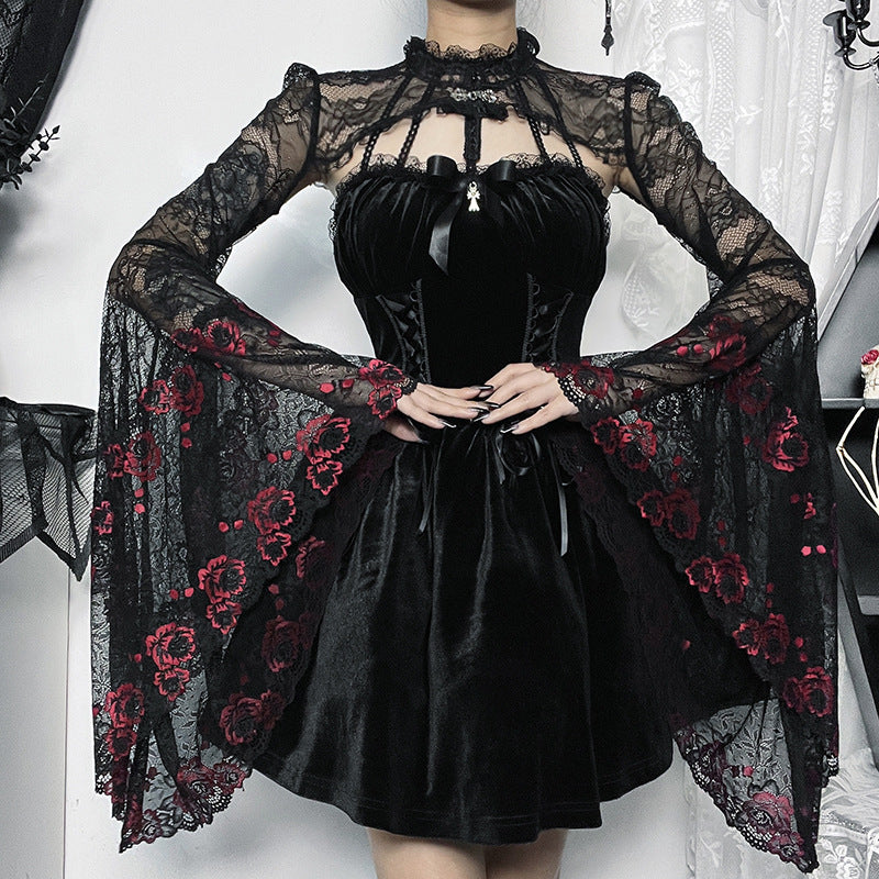 A person wears the Edgy Gothic Blouse - Shop Dark Goth Style Top for Women by Maramalive™ with lace sleeves and a high neckline, exuding goth style. The lace features red floral embroidery on the sleeves, and the slim fit outfit is accessorized with a small pendant at the neck.
