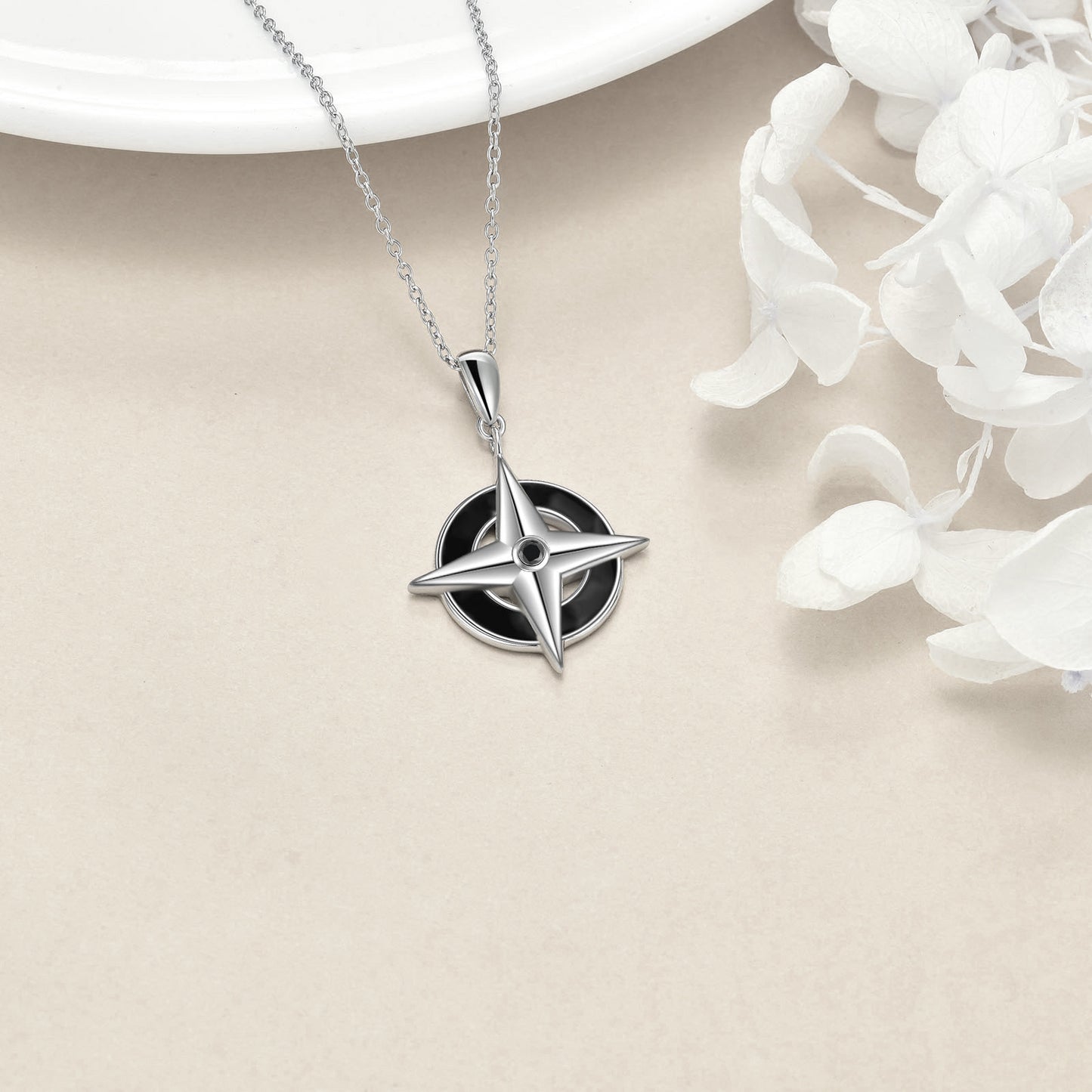 A Maramalive™ Enamel Compass Necklace - Sterling Silver on a chain.