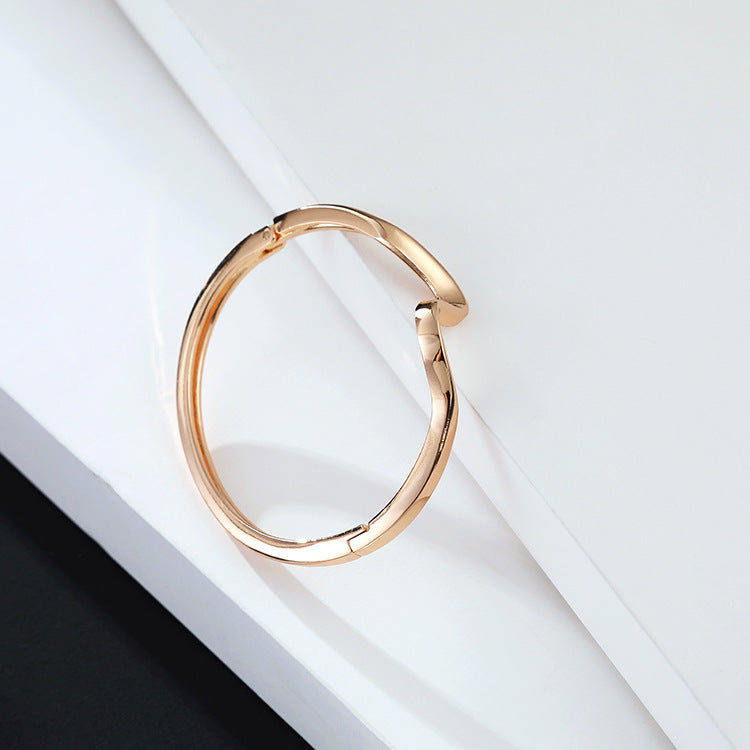 A Maramalive™ Gold-plated Minimalist Lightning Bracelet with a curved shape.