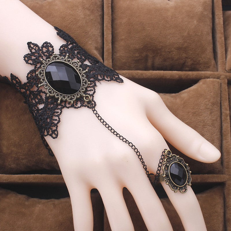 A hand with a Maramalive™ Vintage Gothic Lace Gem Bracelet - Steampunk, Wrist cuff and ring on it.