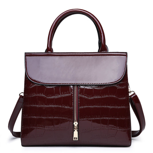 The burgundy patent leather handbag by Maramalive™ features a crocodile pattern and a zipper pocket.