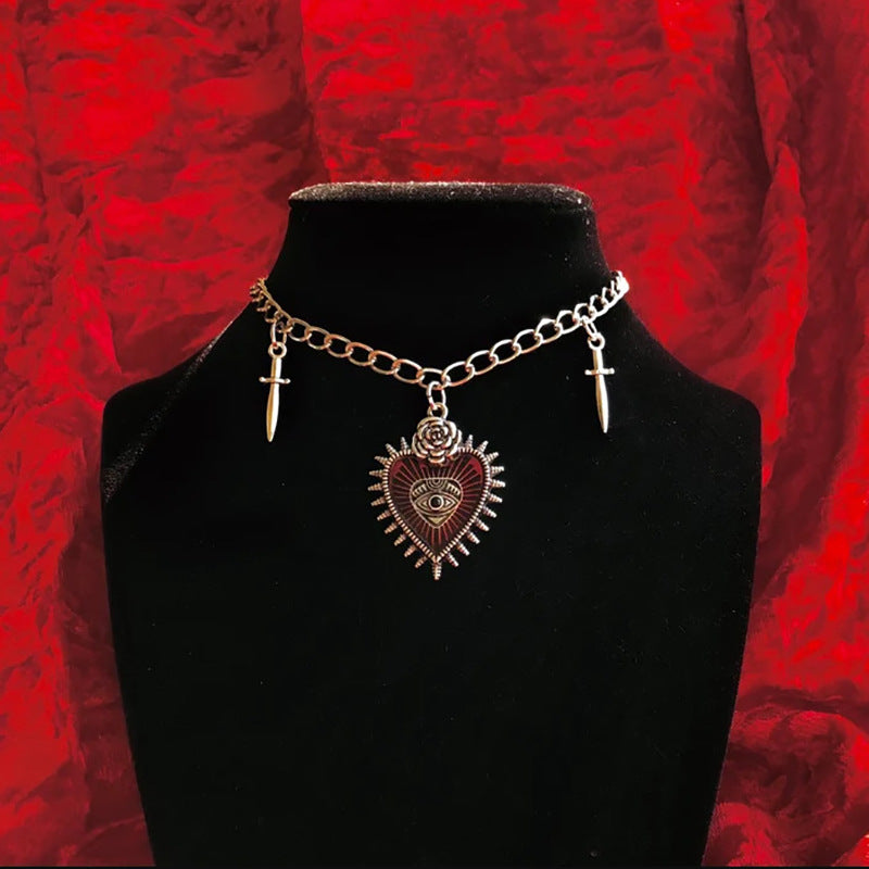 A Maramalive™ New Vintage Gothic Halloween Heart Ornament Necklace with a heart and two swords on a red background.