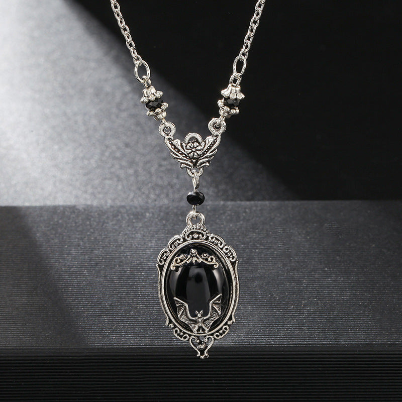 A Halloween Animal Bat Black Gem Necklace with a silver chain by Maramalive™.