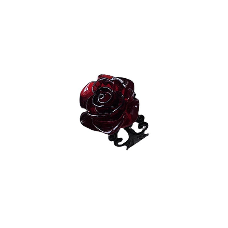 A Red Gothic Rose Ring sits on top of a white lace by Maramalive™.