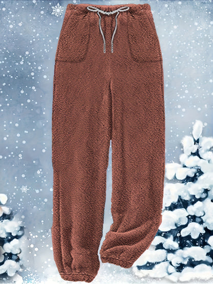 Brown, fuzzy sweatpants with an elastic waistband and drawstring, displayed against a snowy background with snowflakes and snow-covered trees, pair perfectly with the Plus Size Casual Outfits Two Piece Set, Women's Plus Cat Print Fleece Long Sleeve Button Decor Hoodie & Pants Outfits 2 Piece Set by Maramalive™ for a complete winter look.