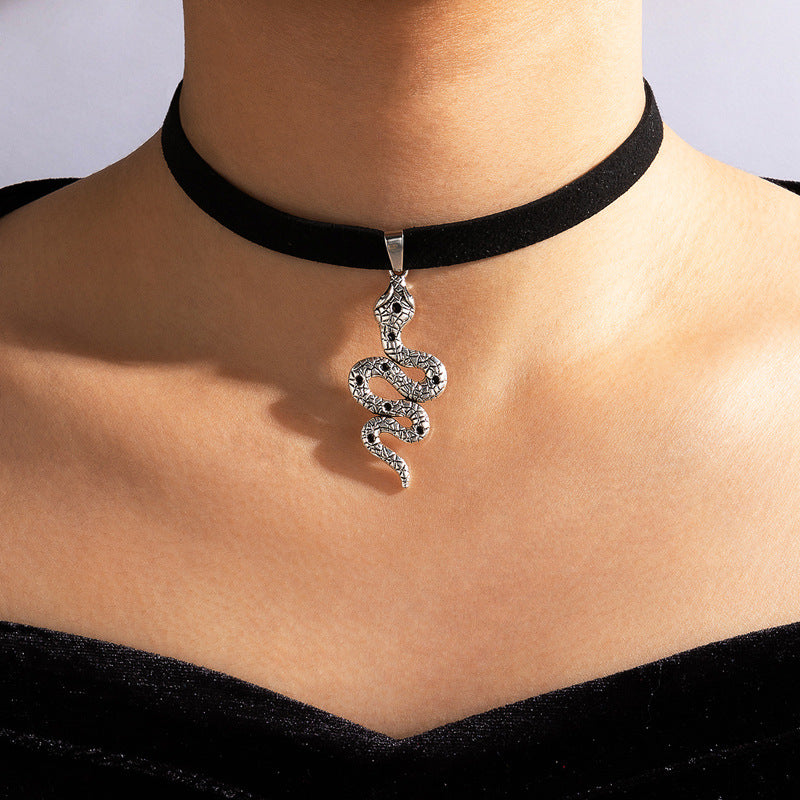 A woman wearing a Maramalive™ Velvet Gothic Choker Necklace with a snake pendant.