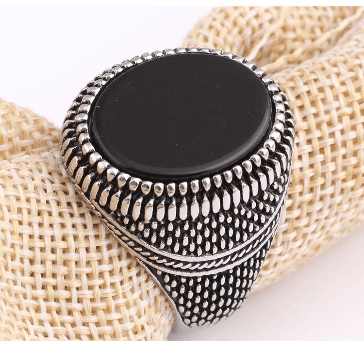 A European And American New Black Onyx Retro Ring Men's Fashion Ring on a brown cloth by Maramalive™.