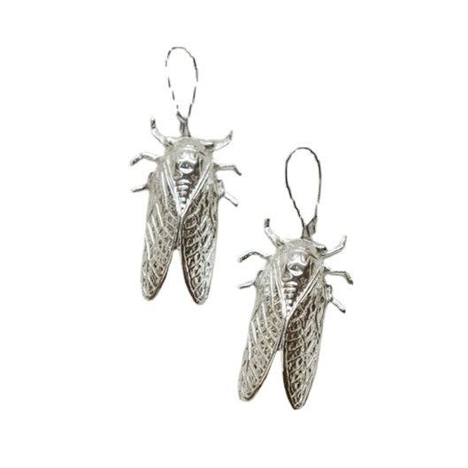 A person holding a pair of Maramalive™ Gothic Cicada Earrings.