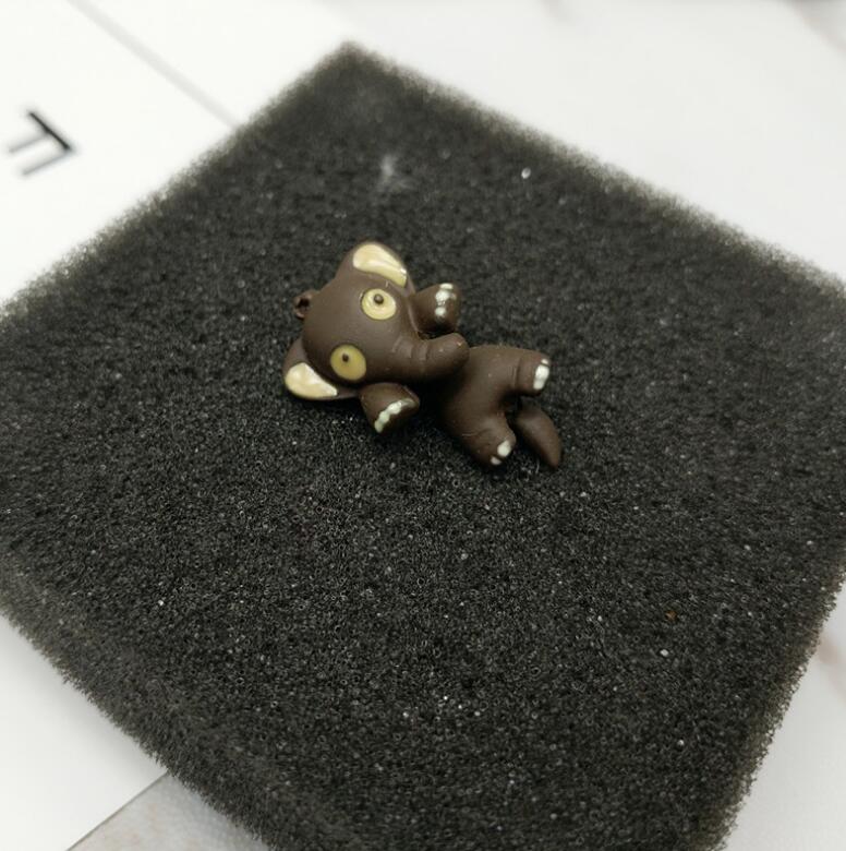 A pair of Maramalive Elephant Earrings sitting on top of a black sponge.