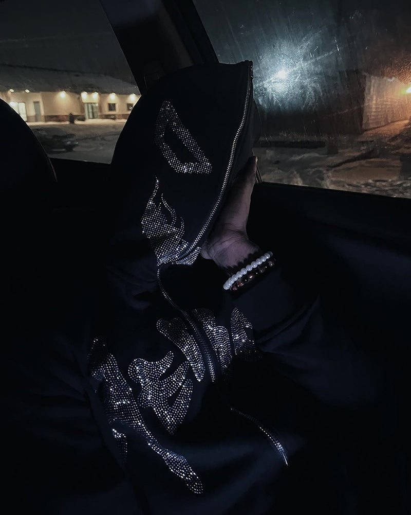 A man with a super attitude in a unisex gothic dark Diamante-Studded Hoodie Sweatshirt for Edgy Style by Maramalive™ standing next to a gas pump.