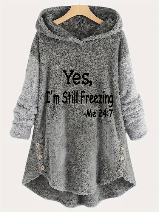 A gray Maramalive™ Letter Print Fuzzy Hoodie, Winter & Fall Oversized Casual Hooded Sweatshirt with the text "Yes, I'm Still Freezing -Me 24:7" on the front. Made from 100% polyester, this women's casual hooded sweatshirt has a plush, fuzzy texture and features button details on the sides. It's perfect for cold days and is machine washable for easy care.