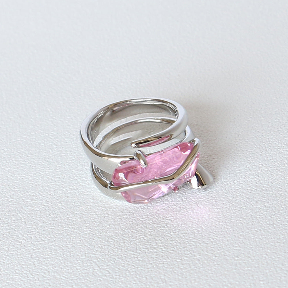 A Zircon Ring Peach Blossom Rose Crystal by Maramalive™ with a pink stone in it.